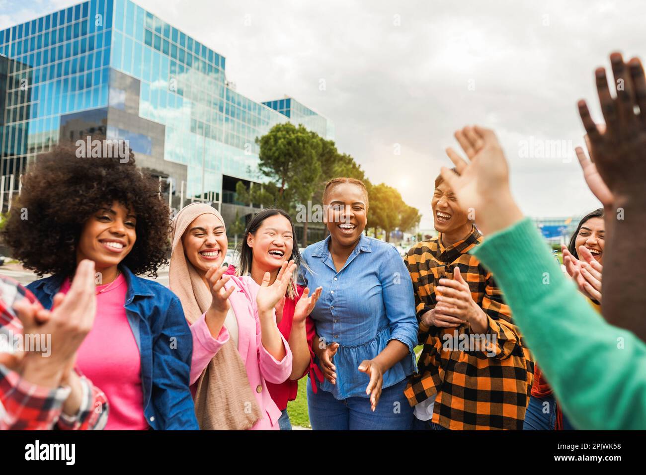 Young diverse people celebrating together outdoor - Focus on curvy african girl face Stock Photo