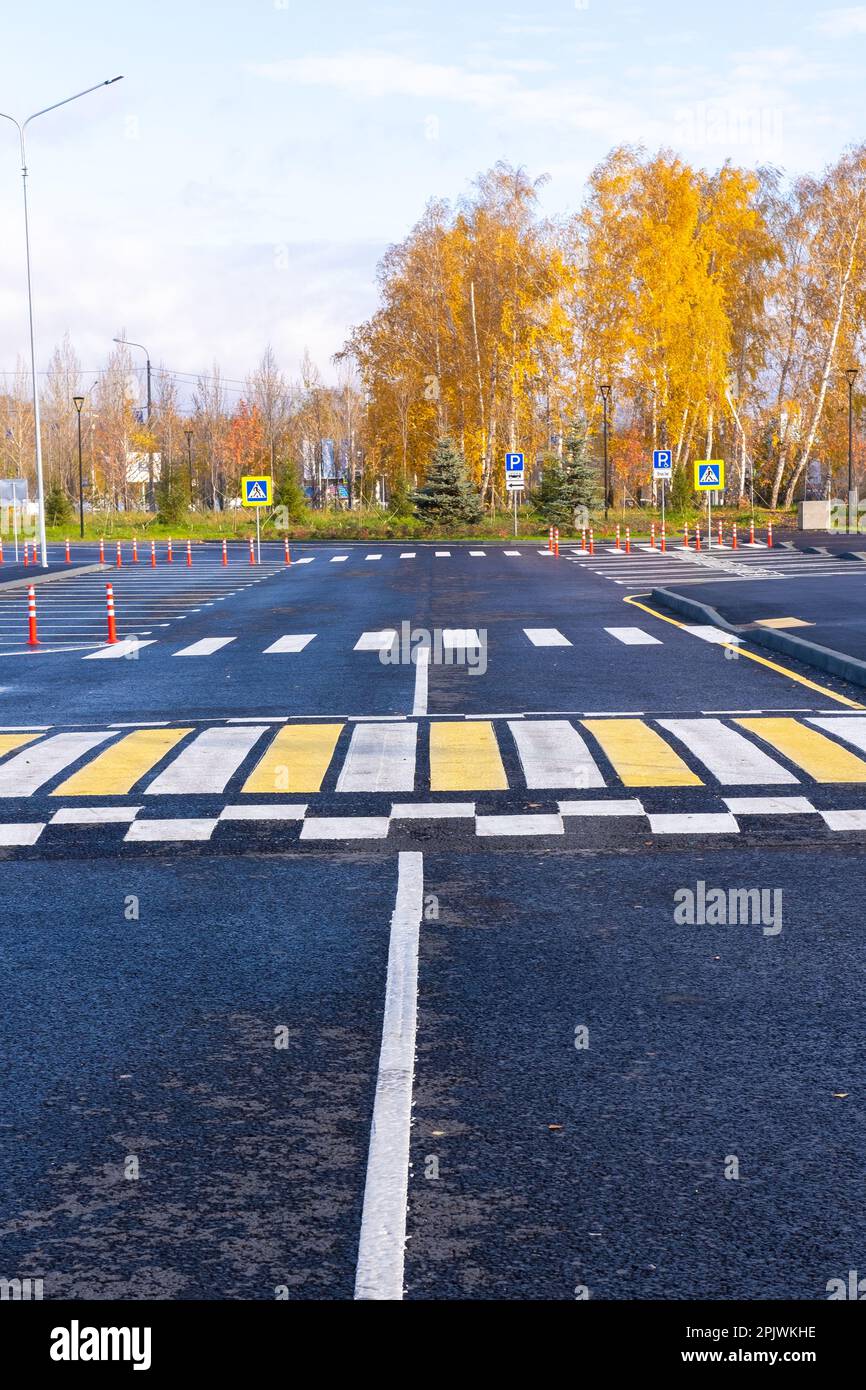 The white and yellow lines of the pedestrian crossing at the