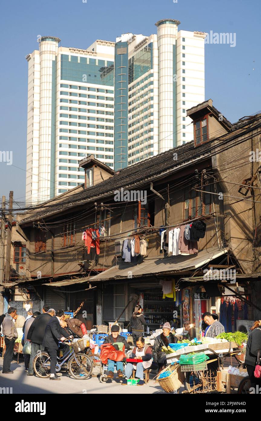 The north-eastern districts of the city of Shanghai: the traditional Shikumen houses surrounded by high-rise buildings. Shanghai, China, Asia Stock Photo