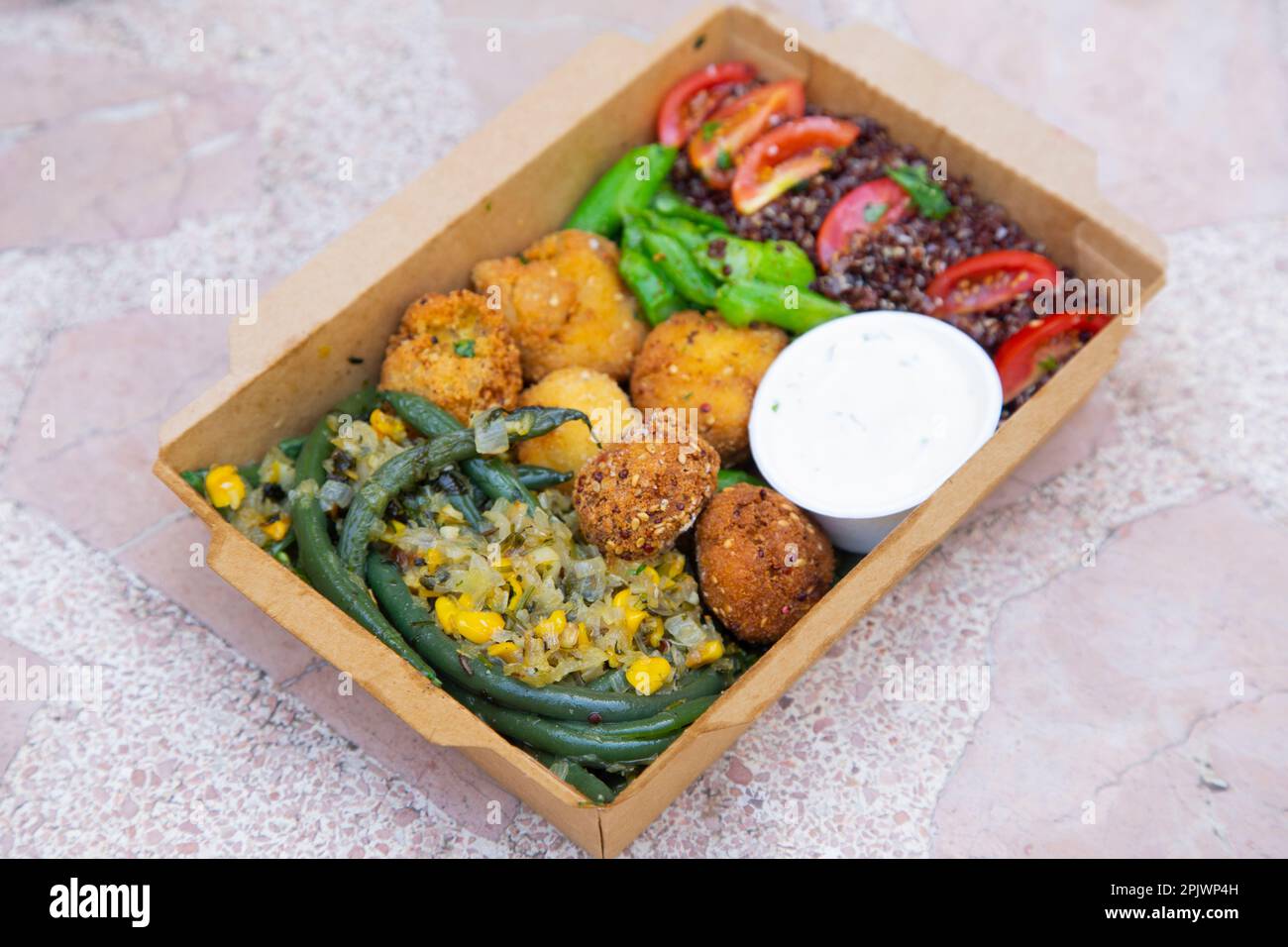 Food box with vegetables and vegan croquettes. Delicious healthy