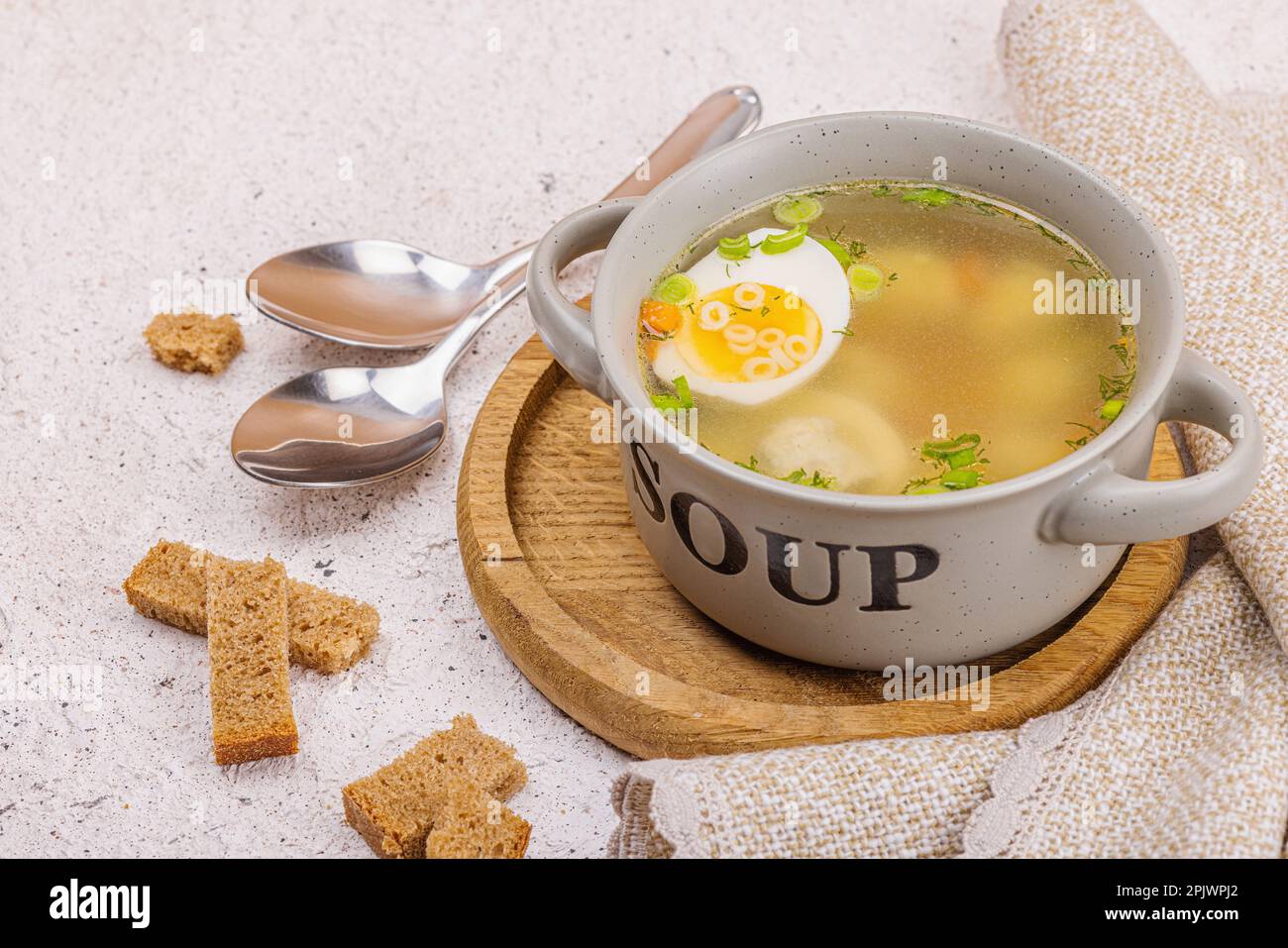 Meatball soup with boiled egg, ditalini pasta, vegetables and fresh herbs.  Healthy chicken broth, traditional hot dish for dinner. Hard light, dark sh  Stock Photo - Alamy
