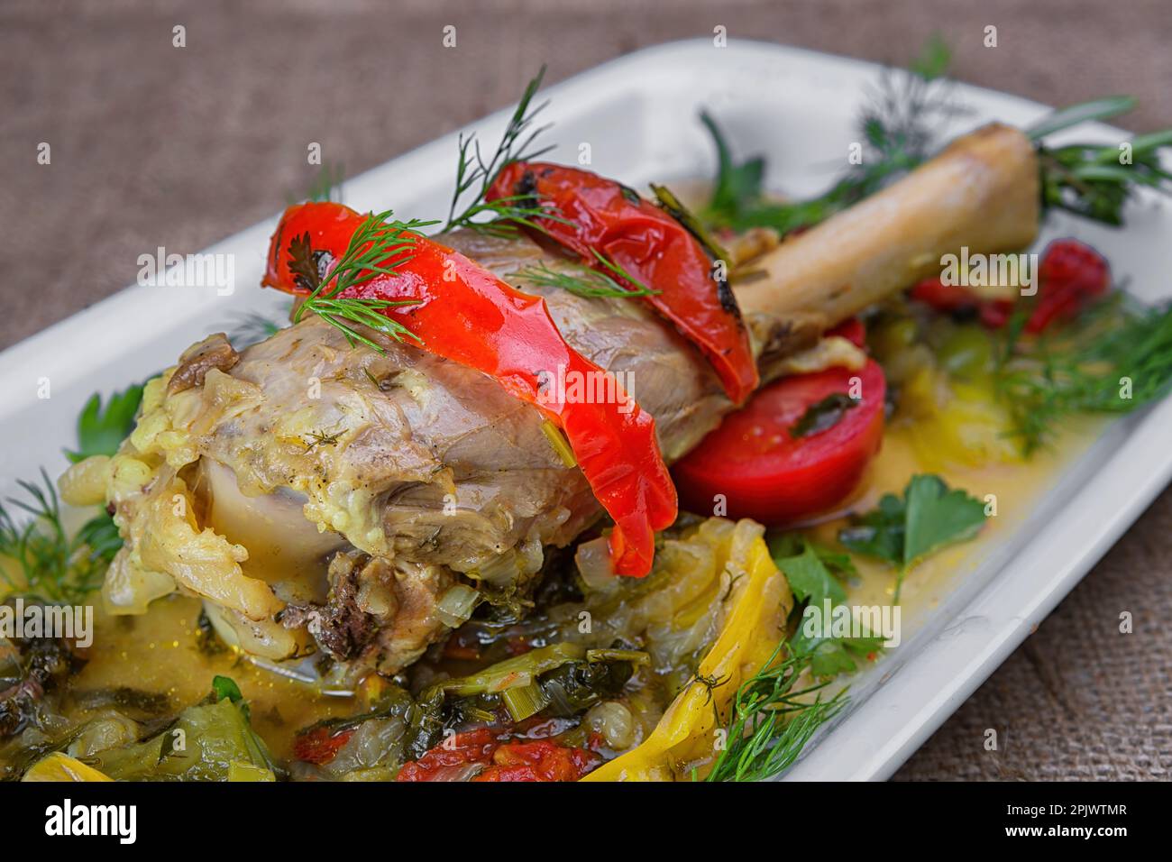 Wholesome and Delicious Lamb Shank Stew with Fresh Herbs and Vegetables Stock Photo