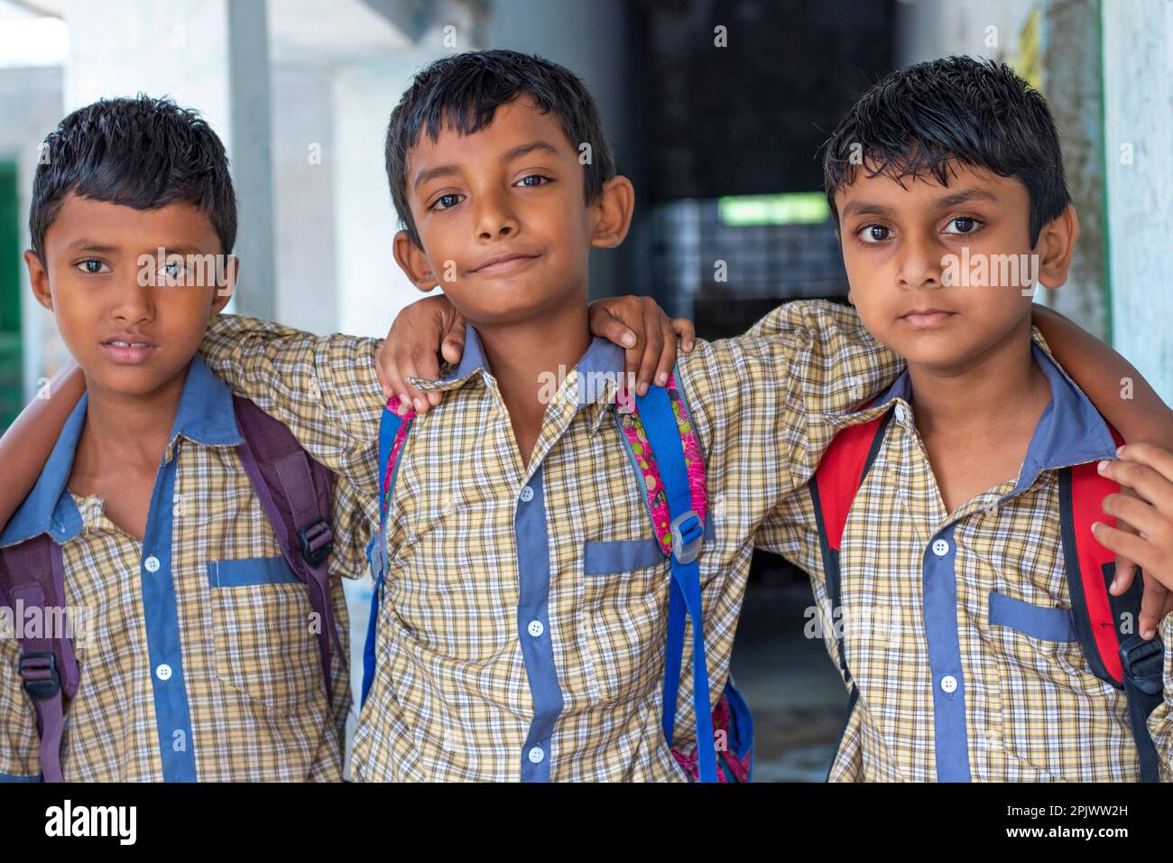 Three school friends with backpack at school Stock Photo