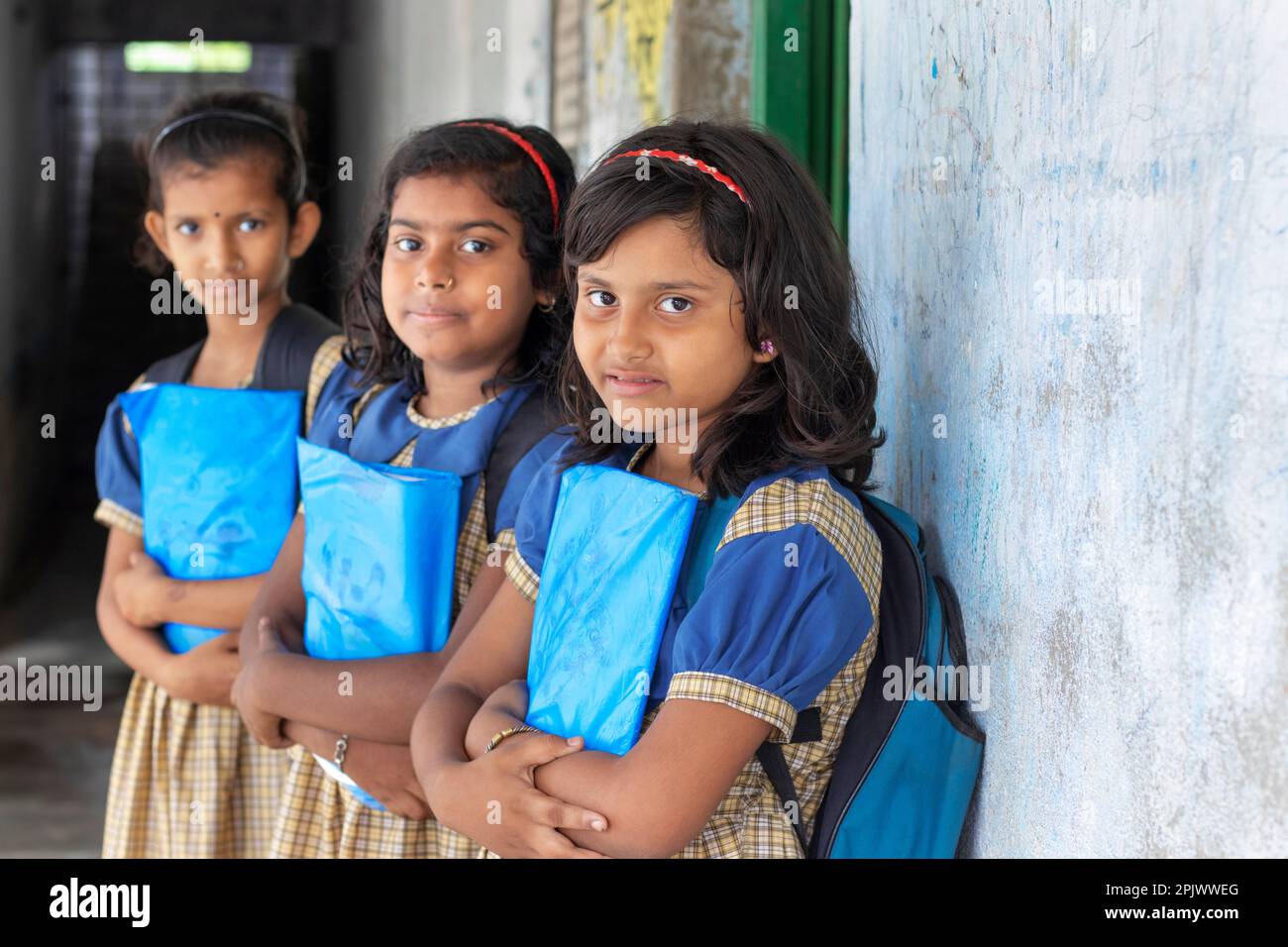 School Children's holding books standing at school Stock Photo - Alamy