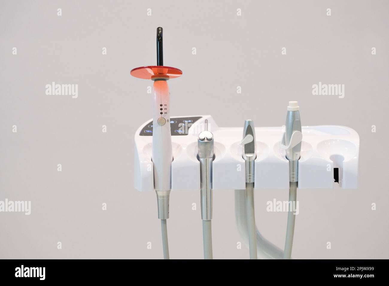 Dental led polymerization inlay onlay devices at dentist office clinic. Selective focus of devices. Open space area. Stock Photo