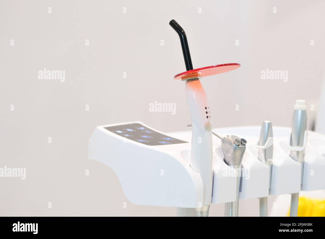 Dental led polymerization inlay onlay devices at dentist office clinic. Selective focus of devices. Open space area. Stock Photo
