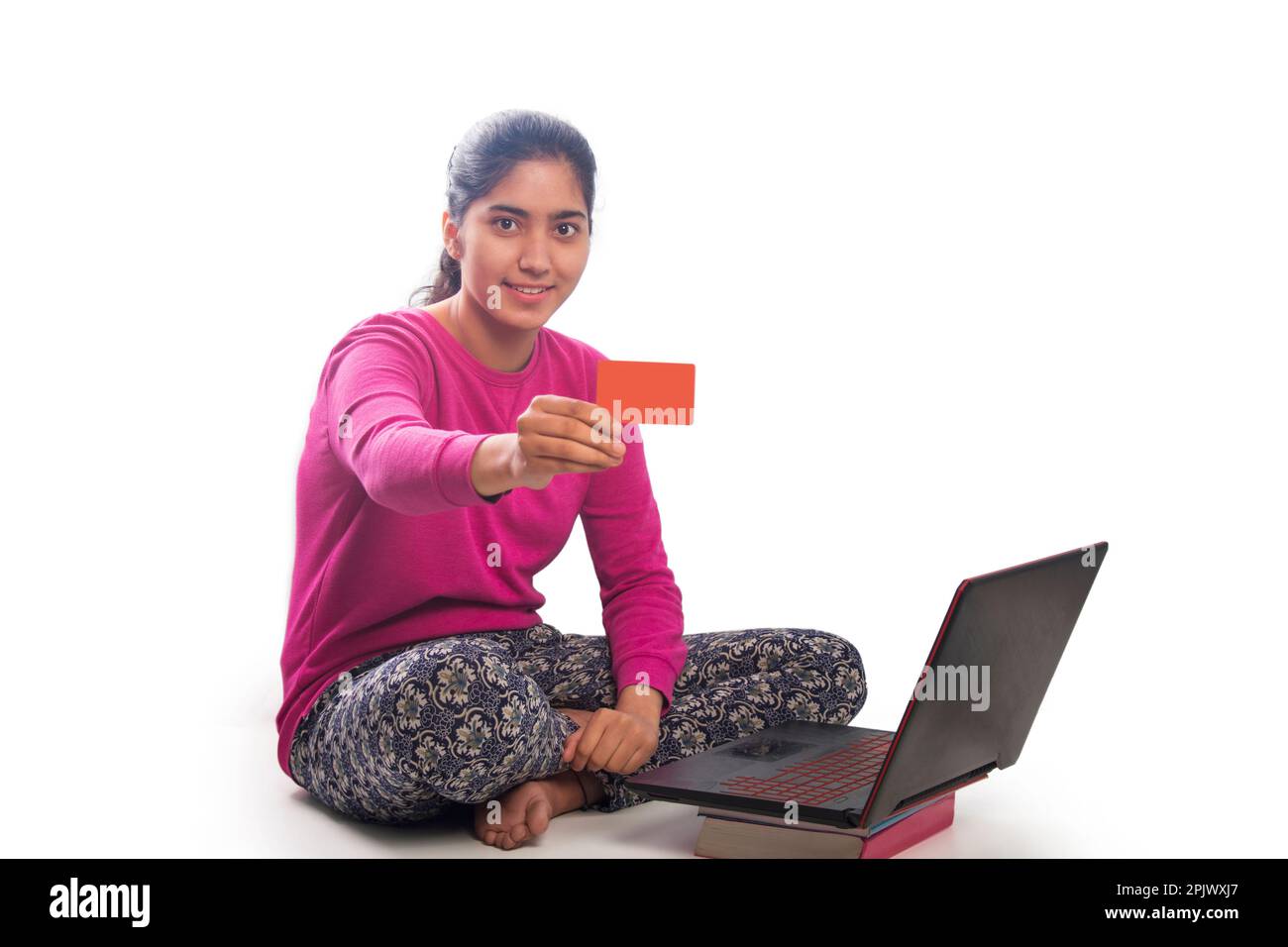 Young college student shopping online and showing credit card Stock Photo