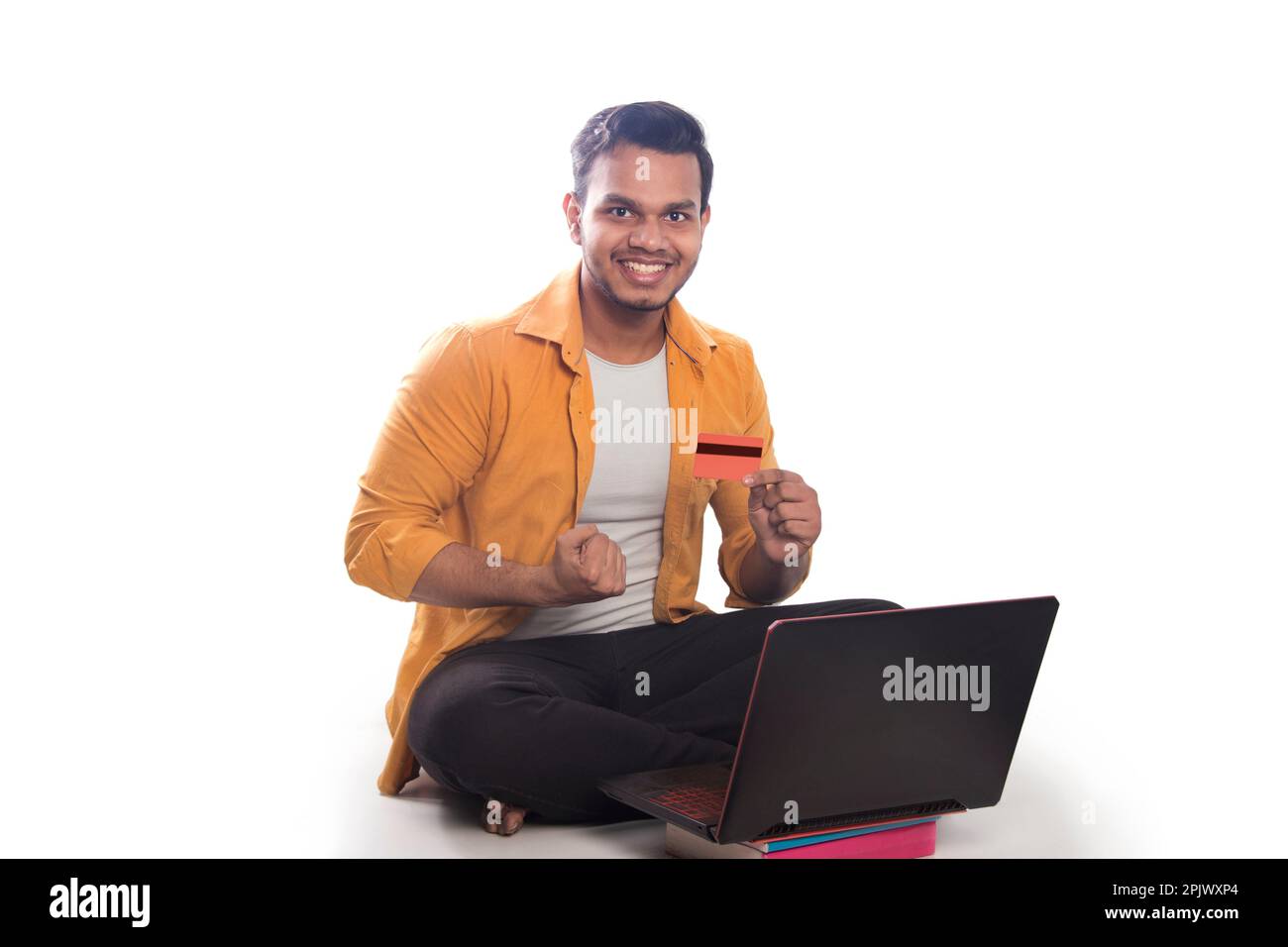 Young college student shopping online and showing credit card Stock Photo