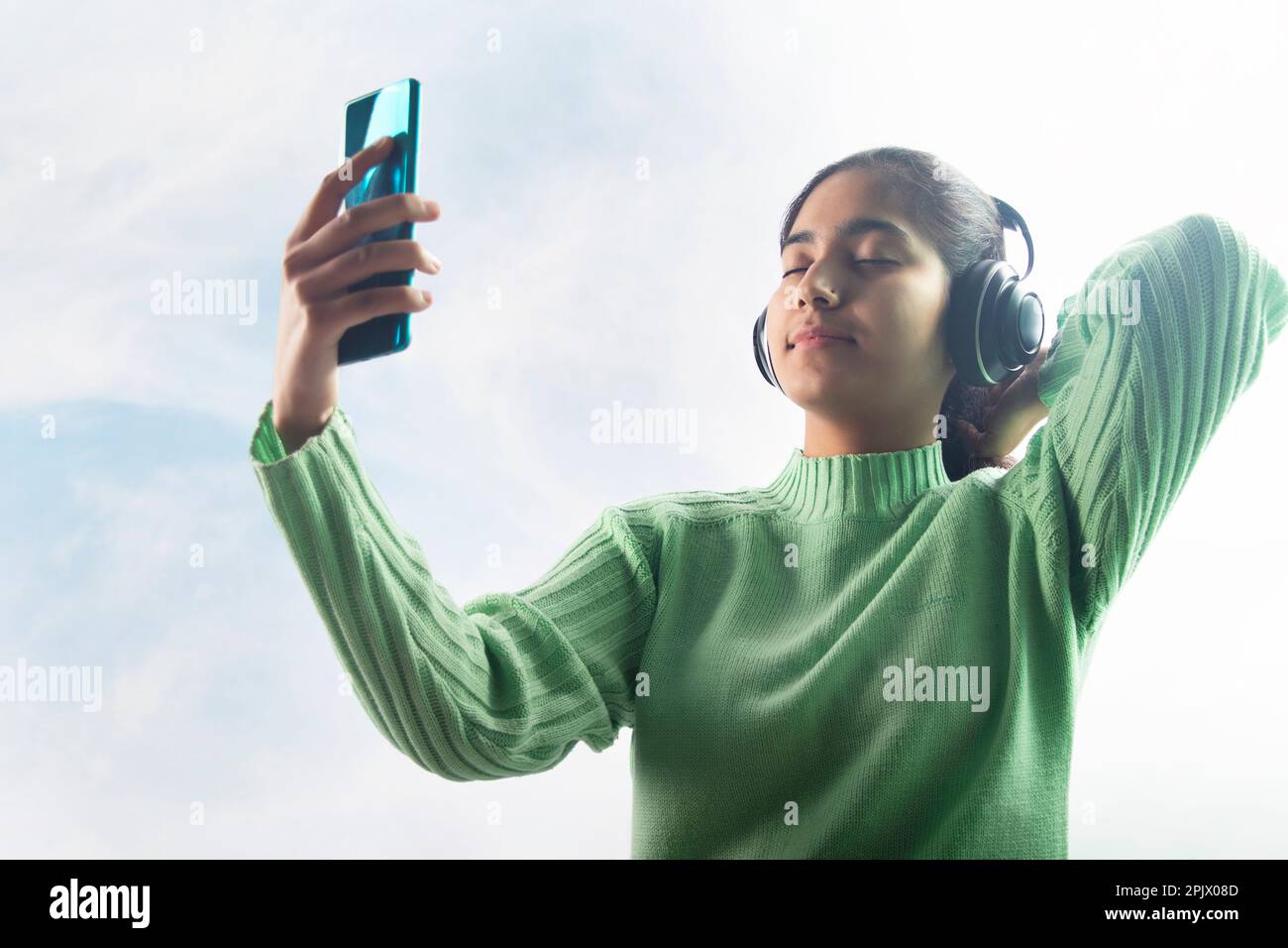 happy young woman enjoying music with headphone and mobile phone Stock Photo