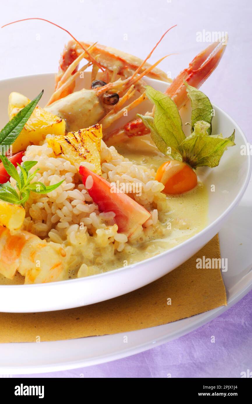A risotto dish with fresh fruit and fried scampi Stock Photo - Alamy