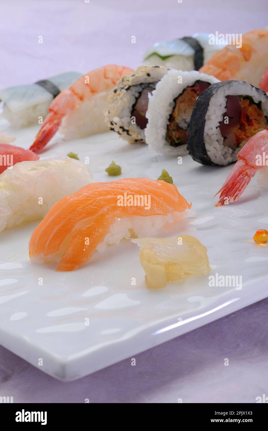 A tray with mixed japanese raw fish, seawood and rice; sushi; sashimi ...