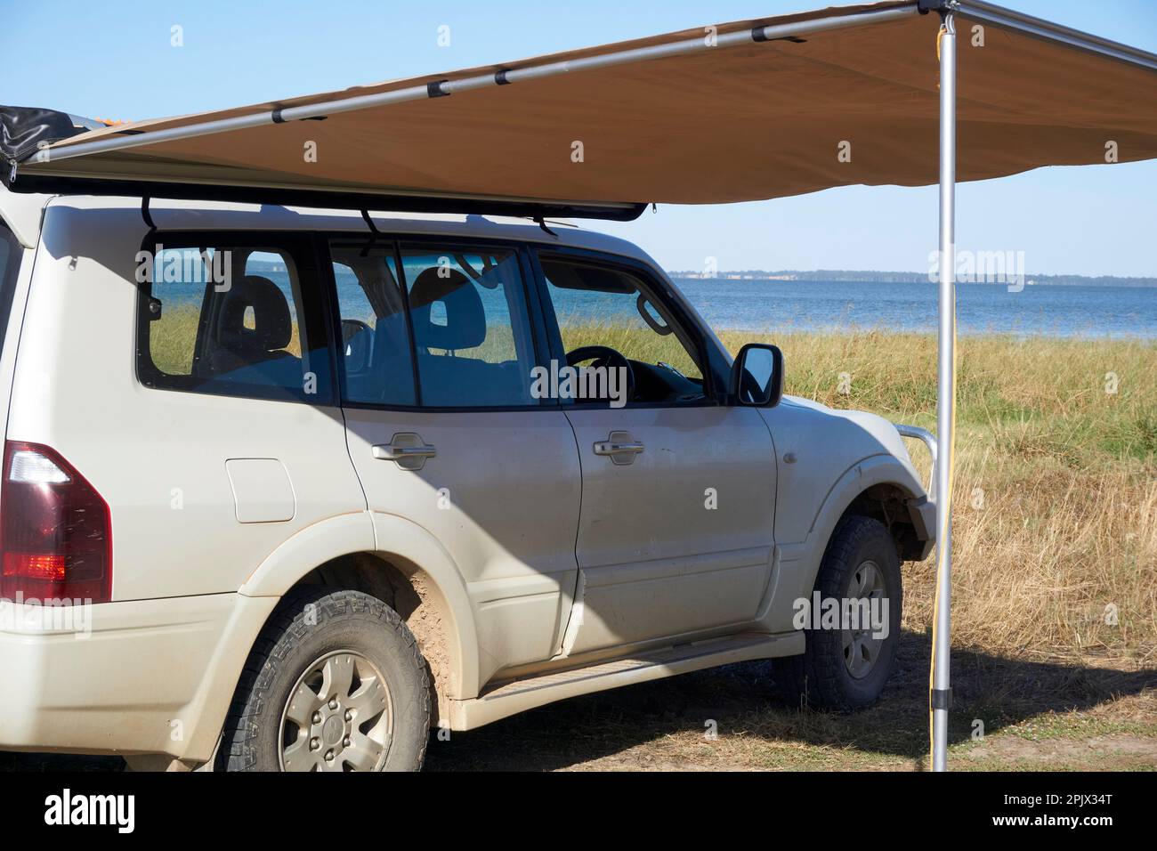 A side view of The side awning extended when attached to a 4x4 for