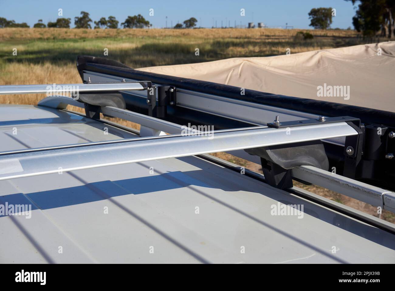 A roof top view of The side awning attached to the roof rack on a 4x4 ...