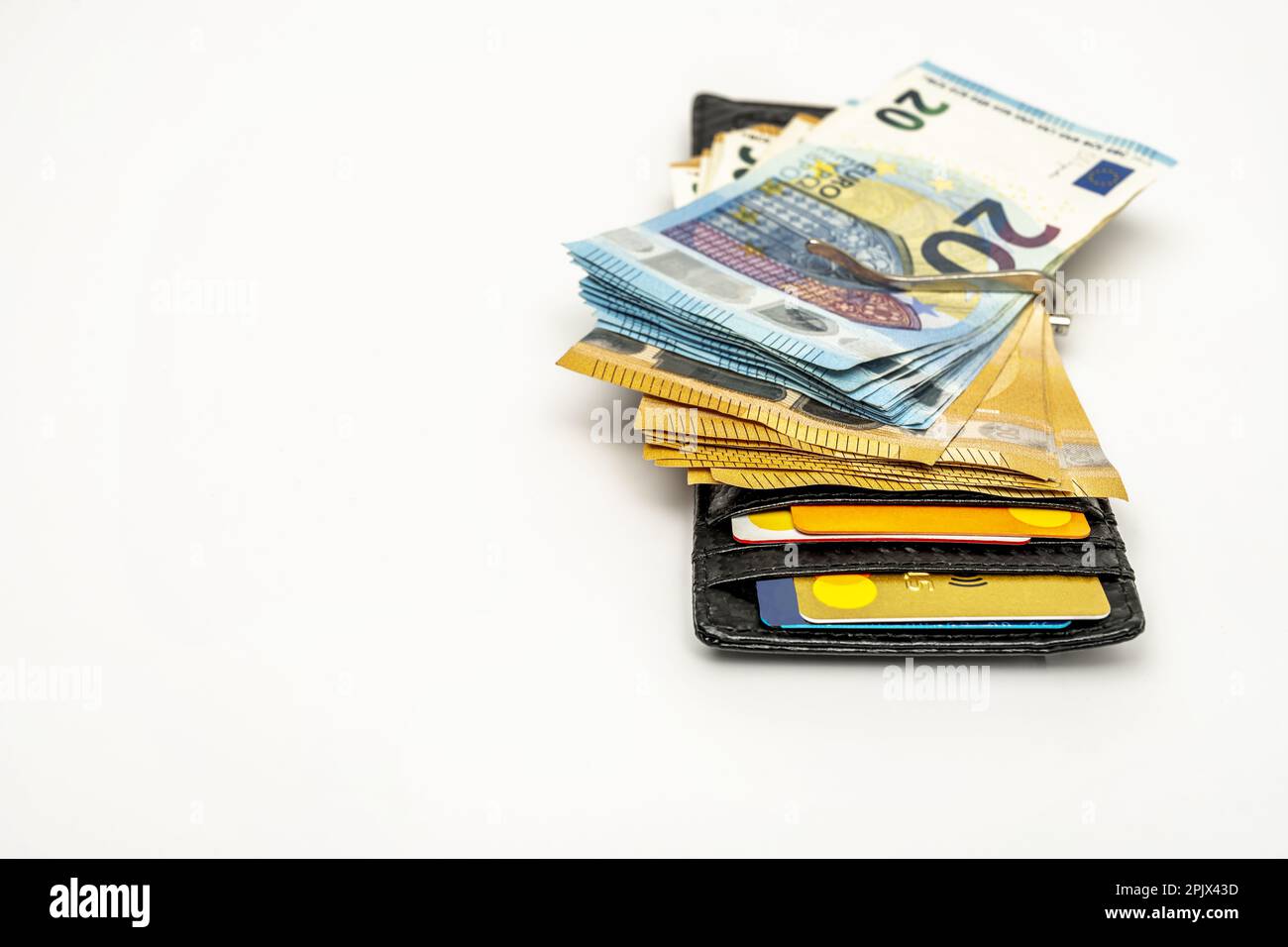 Black men's wallet with a good amount of euro bills, credit cards and a money clip Stock Photo