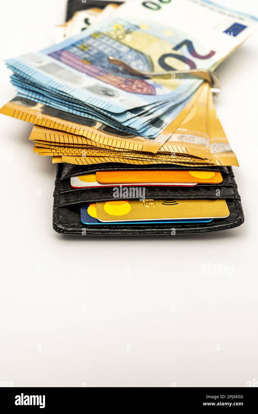 Black men's wallet with a good amount of euro bills, credit cards and a money clip Stock Photo