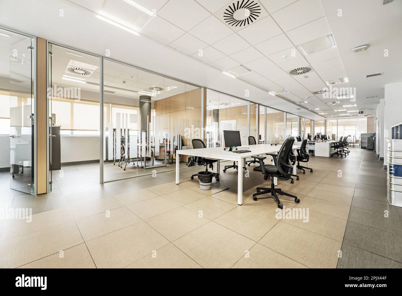 Professional office with large televisions and computer screens, glass