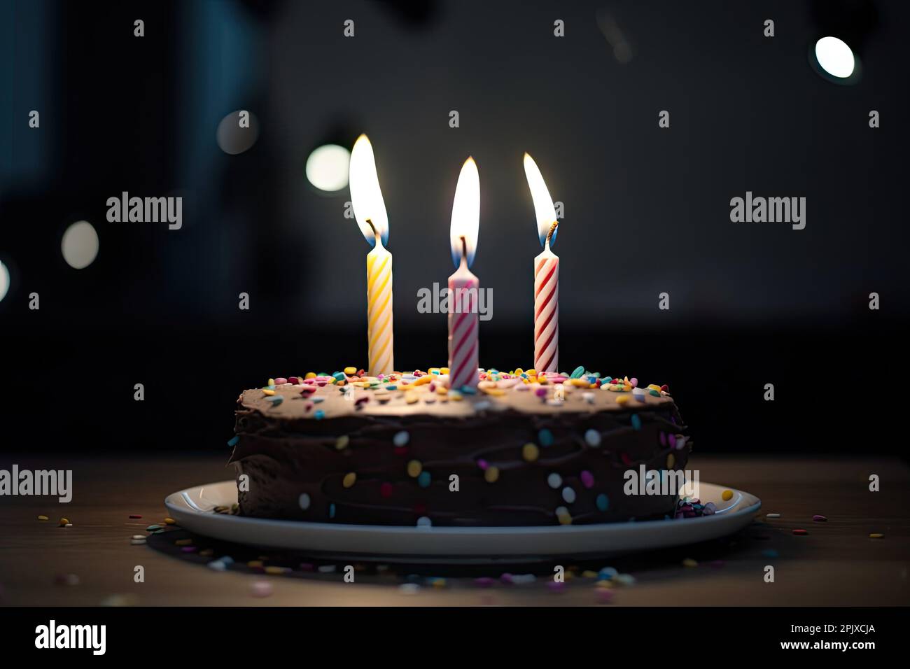 chocolate birthday cake with three candles and colorful sprinkles Stock ...