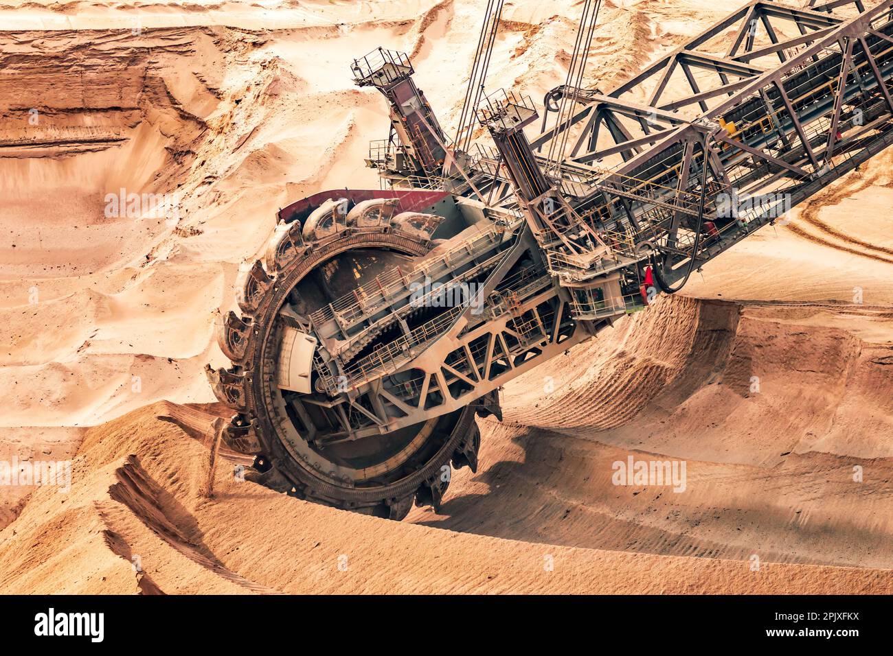 Large bucket wheel excavator mining machine at work in a brown coal open pit mine Stock Photo