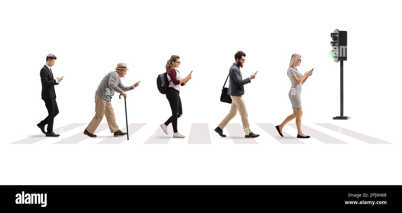 Full length profile shot of people crossing street at a pedestrian