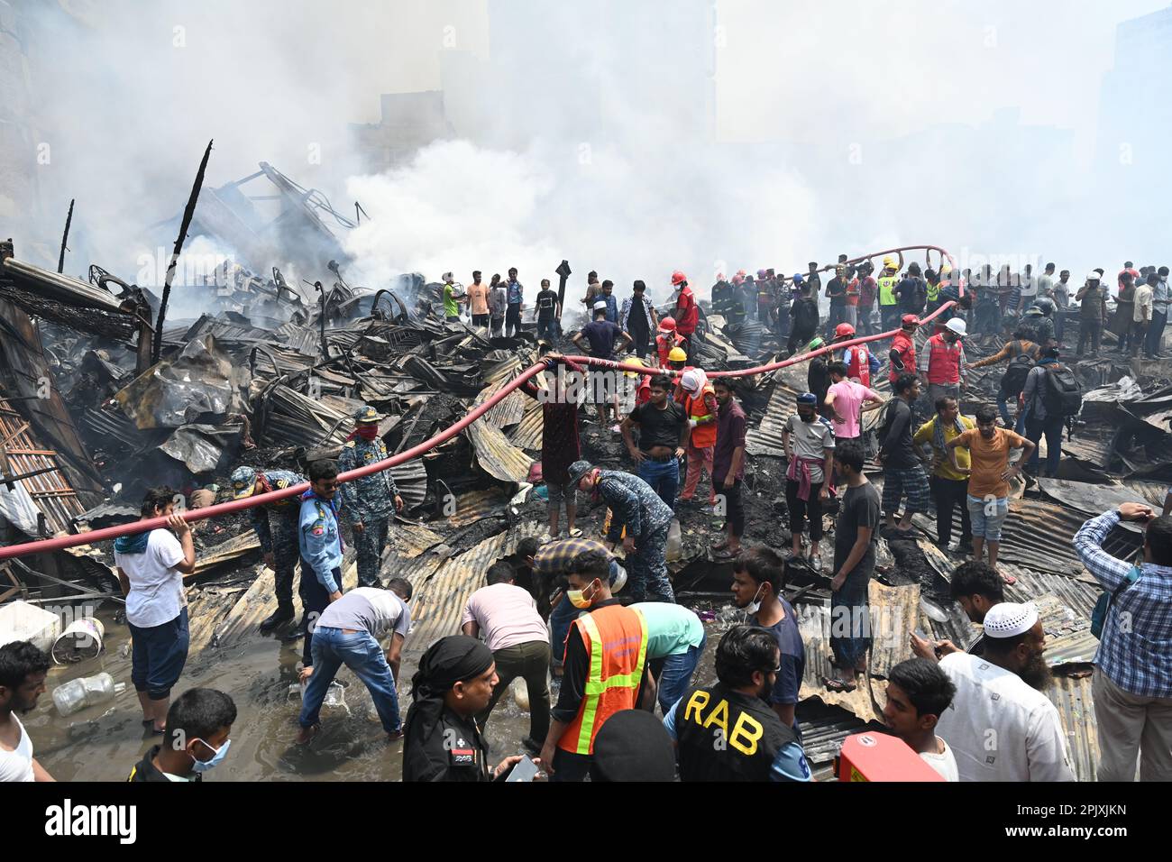 Dhaka, Bangladesh, on April 4, 2023. Firefighters try to extinguish a ...