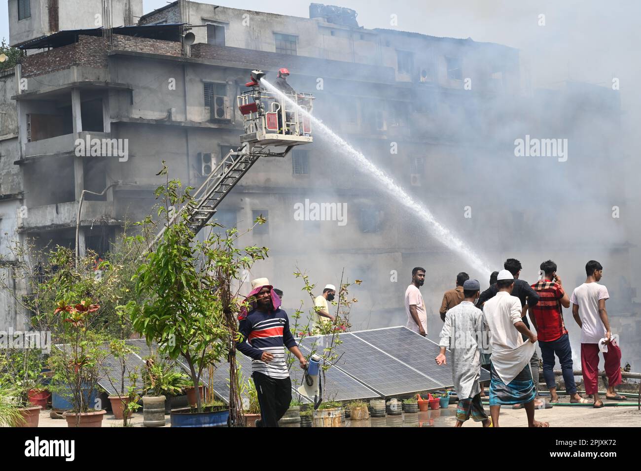 Dhaka, Bangladesh, on April 4, 2023. Firefighters try to extinguish a ...