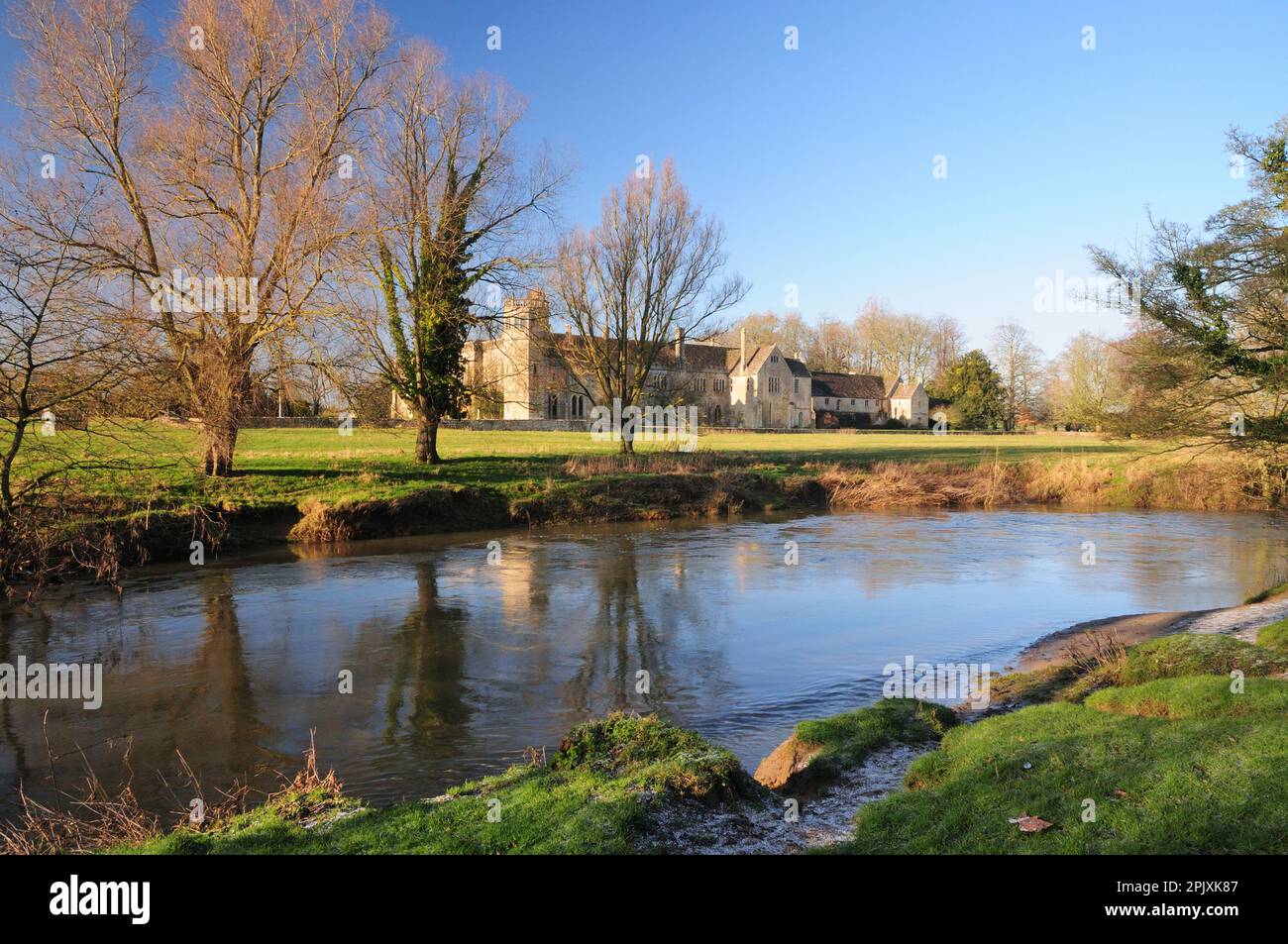 Lacock Abbey, Wiltshire, seen from the opposite bank of the river Avon in winter sunshine. Stock Photo