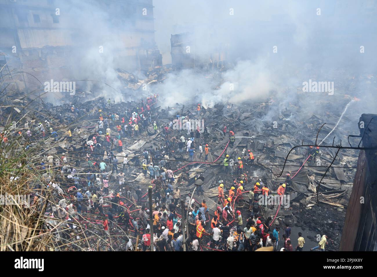 Dhaka, Bangladesh, on April 4, 2023. Firefighters try to extinguish a ...