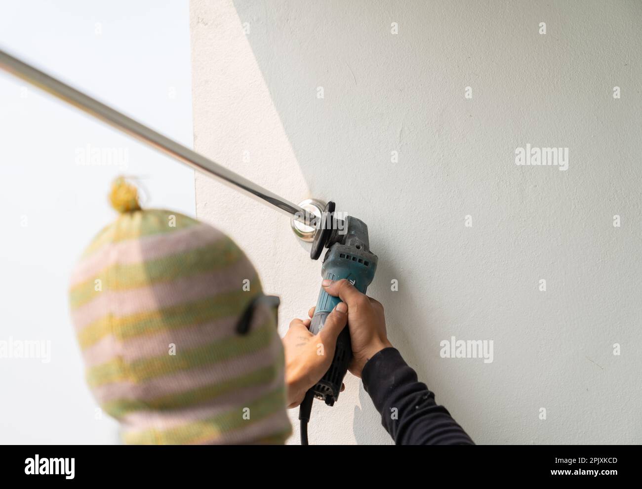 Metal polishing with a hand with a polishing disk.Hand grinder workflow