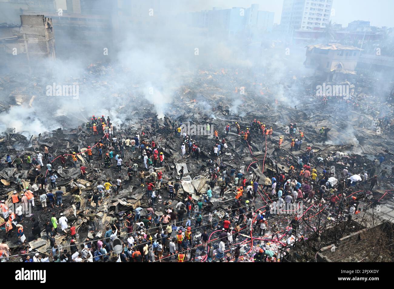 Firefighters try to extinguish a fire that broke out in a clothing ...