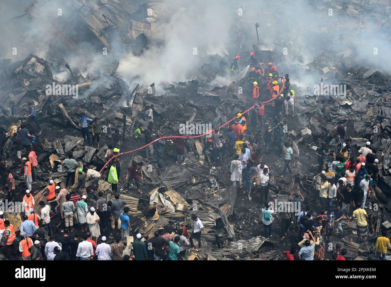 Firefighters try to extinguish a fire that broke out in a clothing ...