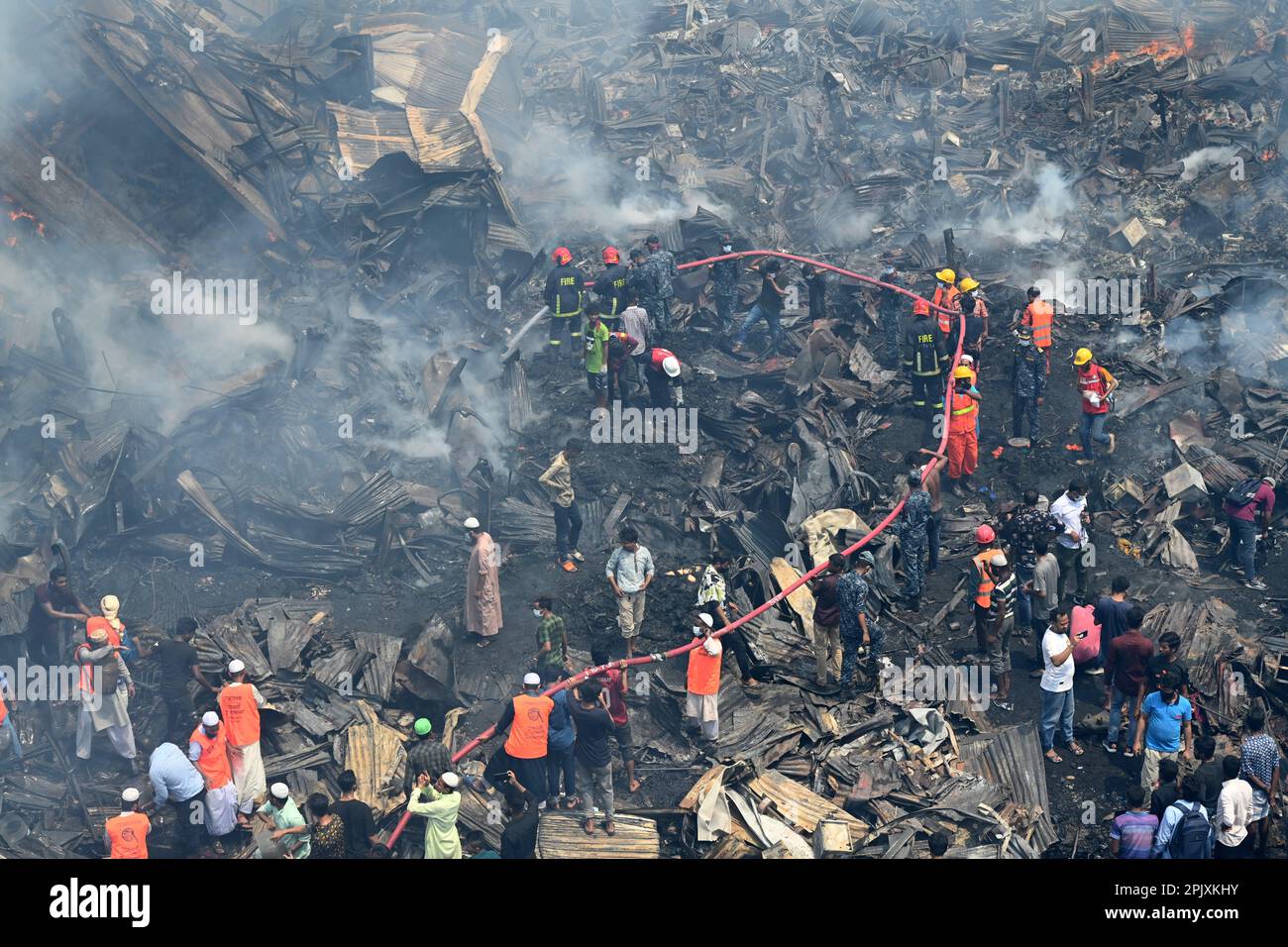 Firefighters try to extinguish a fire that broke out in a clothing ...