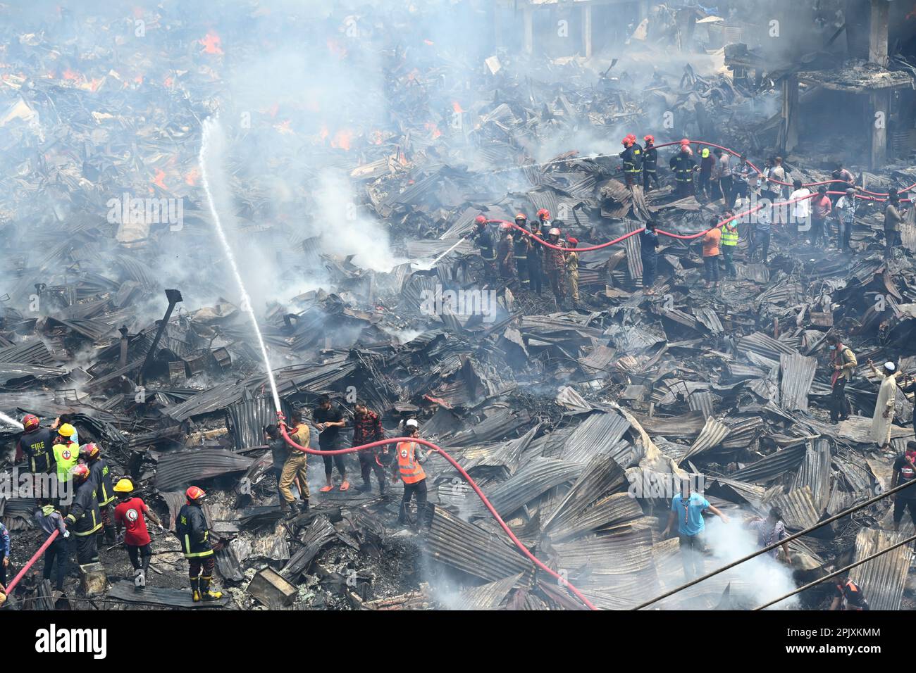 Firefighters try to extinguish a fire that broke out in a clothing ...
