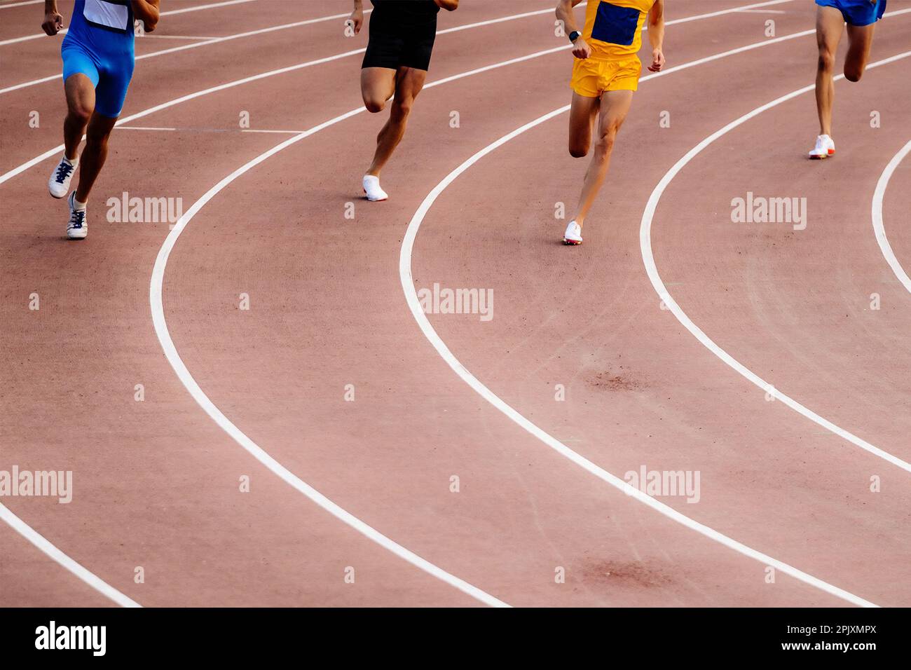 Group Stayer Runners Running Middle Distance Race On Turn Track Stadium Summer Athletics