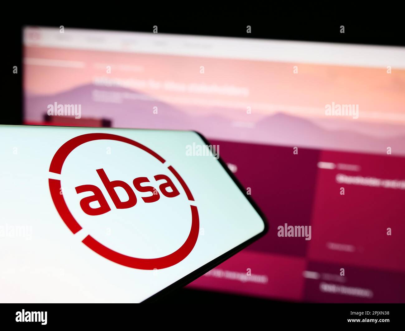 Mobile phone with logo of South African company Absa Group Limited on screen in front of business website. Focus on center of phone display. Stock Photo