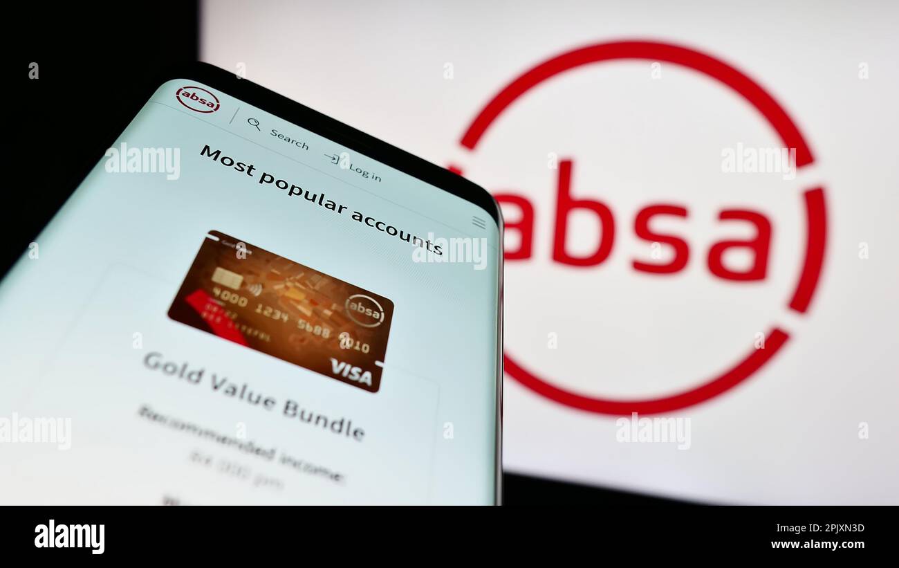 Smartphone with website of South African company Absa Group Limited on screen in front of business logo. Focus on top-left of phone display. Stock Photo