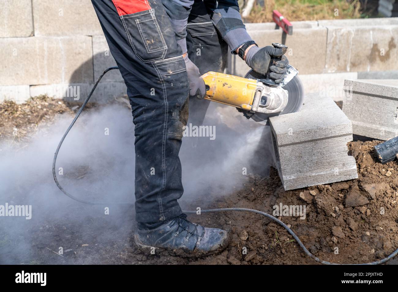 cutting concrete bricks with an electric grinder Stock Photo Alamy
