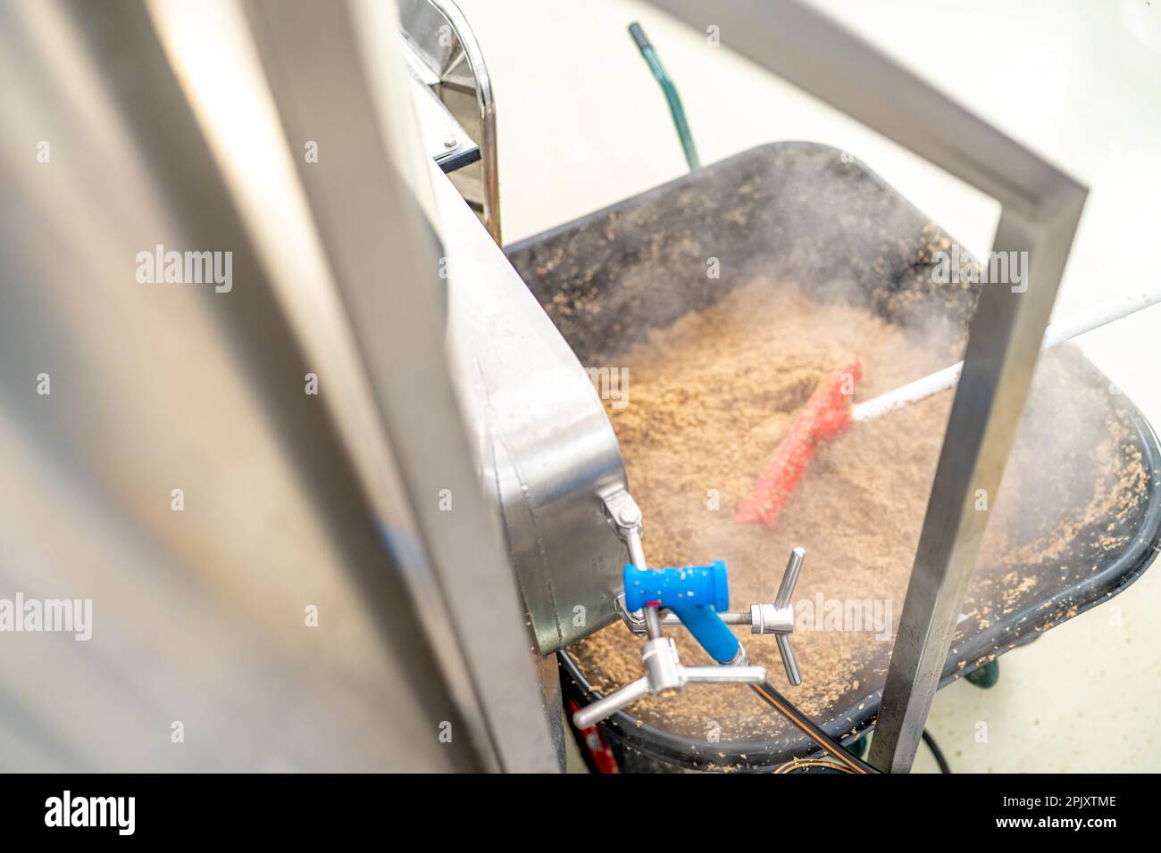cleaning the boiler from residual malt after brewing beer in the