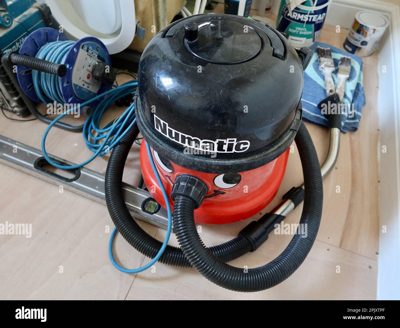 Suffolk, UK - 4 April 2023 : Numatic Henry Hoover vacuum cleaner dusty from use. Stock Photo