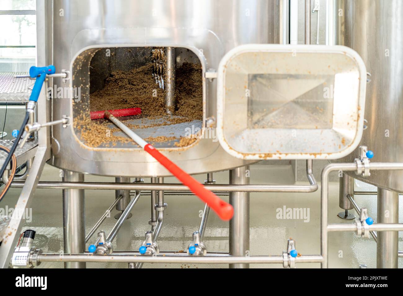 cleaning the boiler from residual malt after brewing beer in the