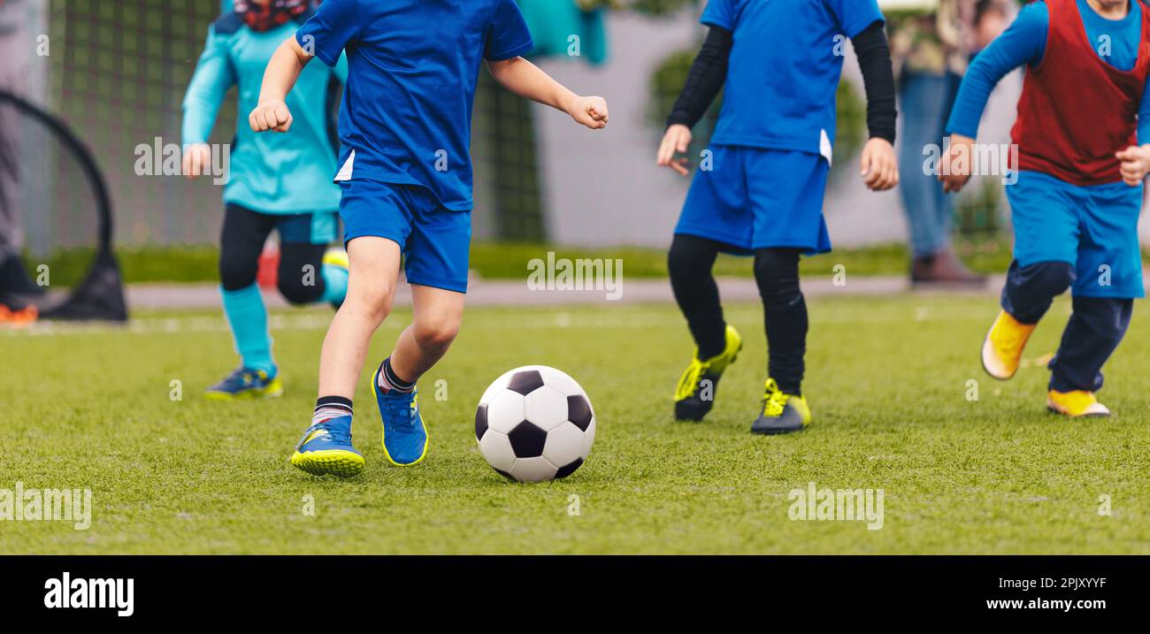 Kindergarten children playing a soccer game at the football pitch