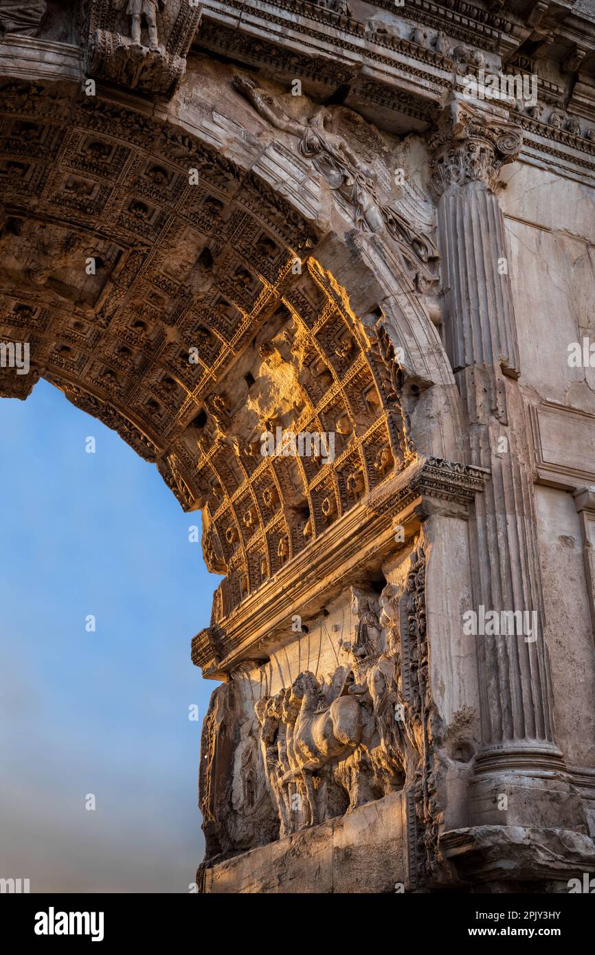 Arch of Titus (Latin: Arcus Titi) architectural details at sunset in Rome, Lazio, Italy. Ancient Roman city landmark built in AD 81 by the Emperor Dom Stock Photo