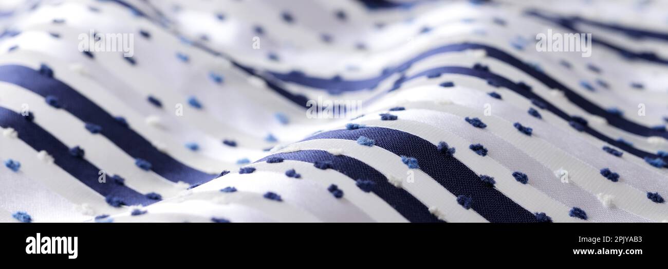 White fabric with dark stripes and dots Stock Photo