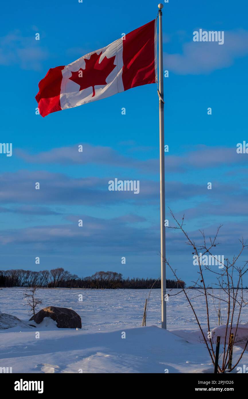 Canadian flag flying at the longitudinal centre of Canada in Tache, Manitoba, Canada Stock Photo