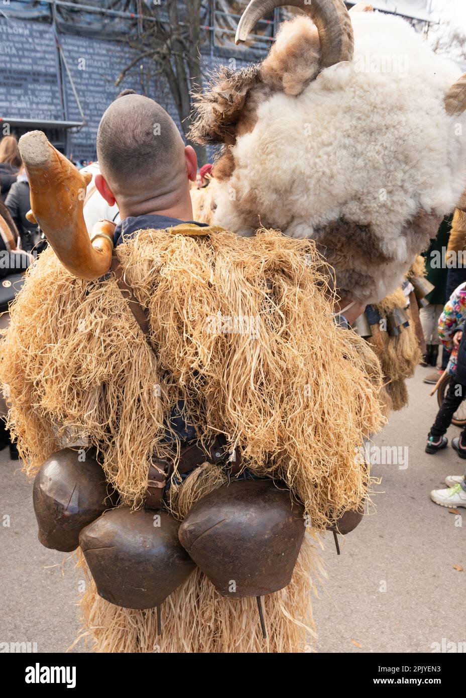 Rear view of male Kukeri dancer with large bells and mask off at the traditional annual Kukeri festival in Sofia, Bulgaria, Balkans, EU Stock Photo