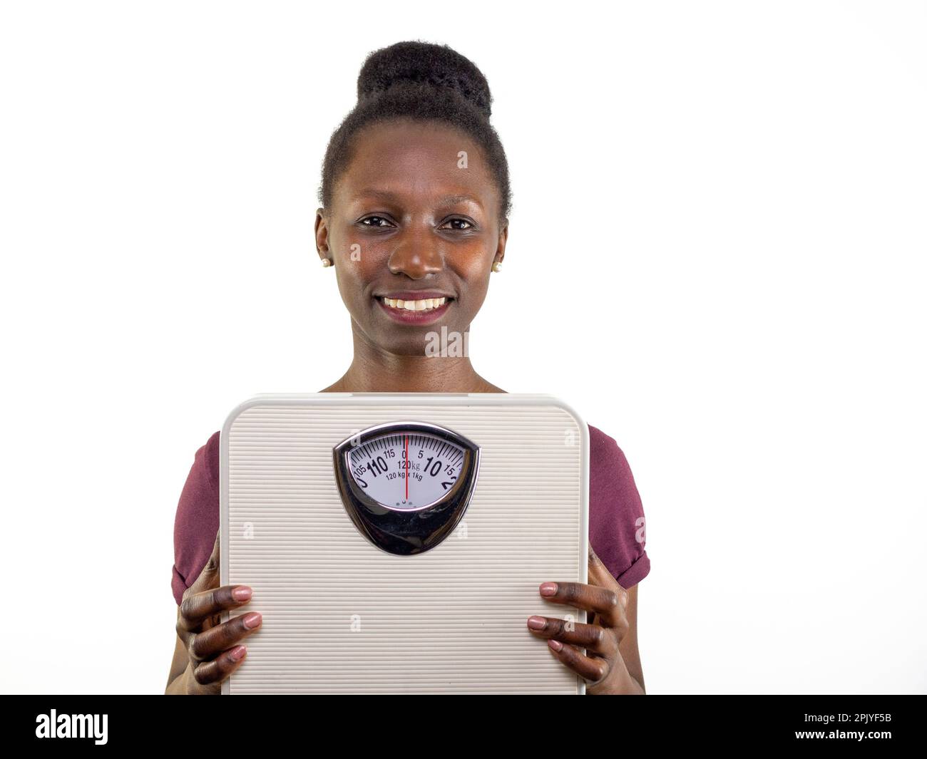 Young woman showing a weight scale isolated on white background Stock