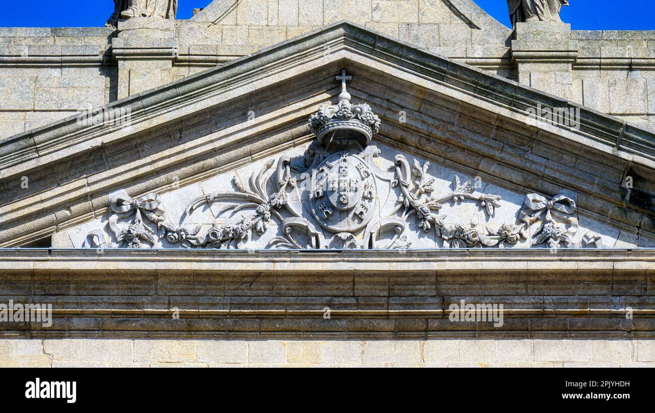Capital close-up shoing a coat of arms and a royal crown. Also known as the Church of Lapa in Porto, the medieval building is a tourist attraction in Stock Photo