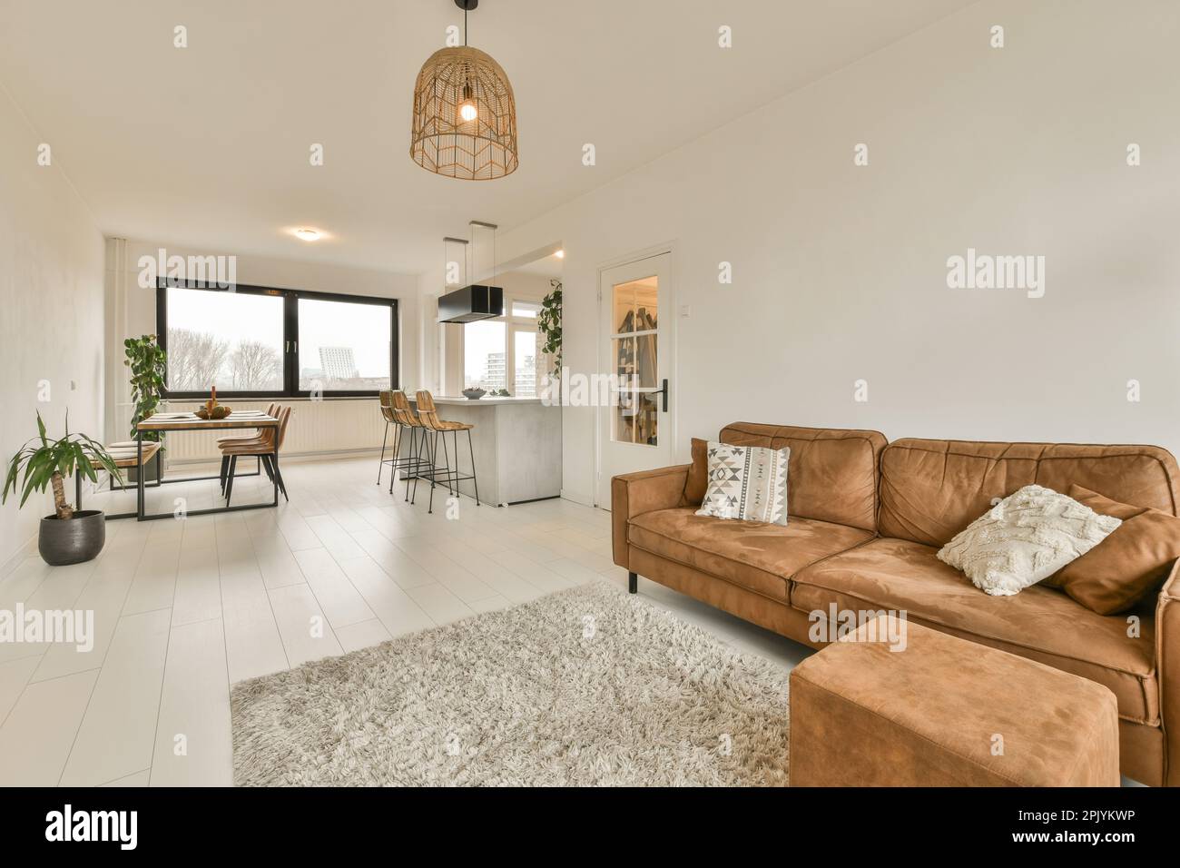 a living room with brown couches and white tiles on the floor in