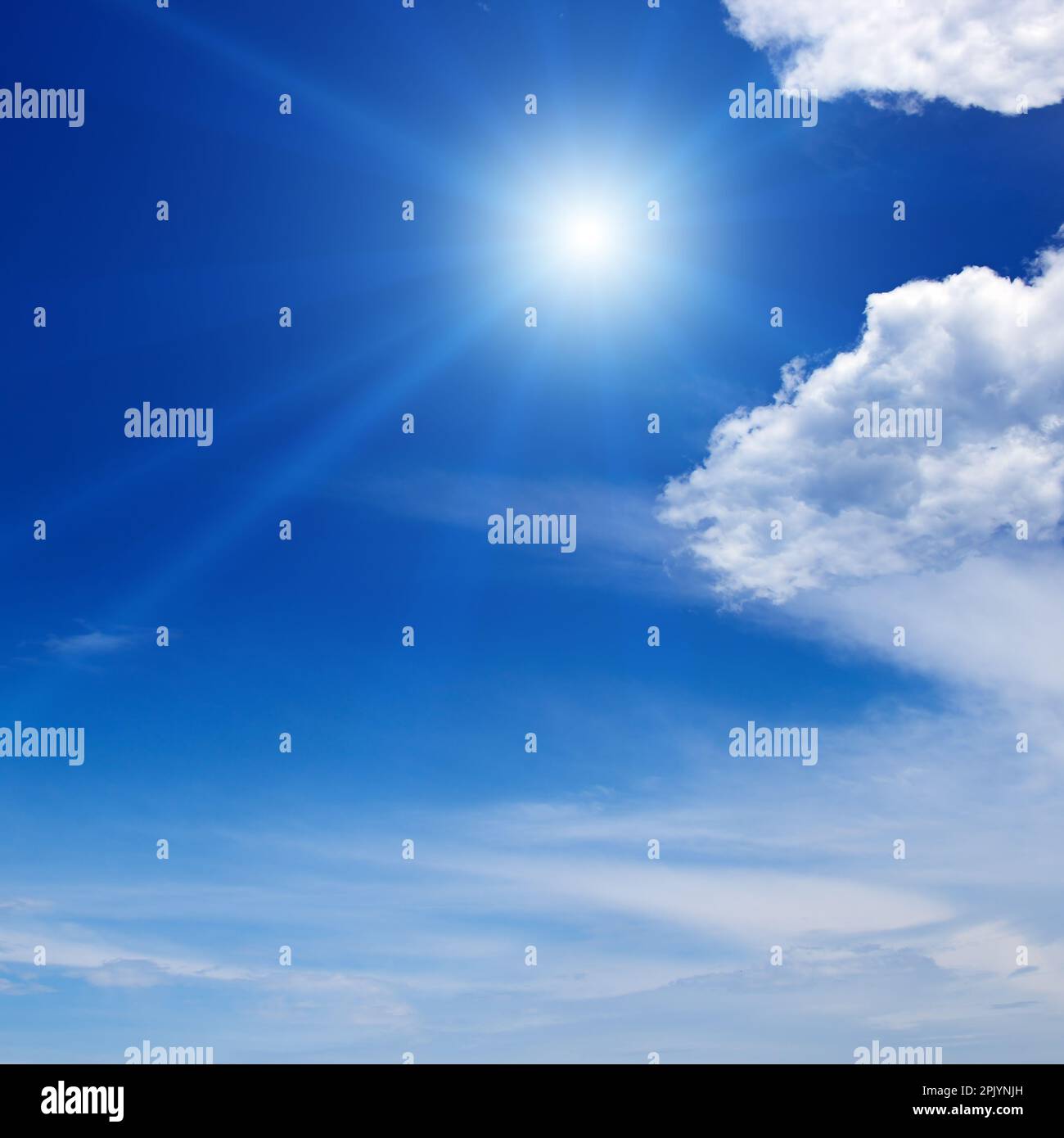 Bright sun on beautiful blue sky with white fluffy clouds Stock Photo ...