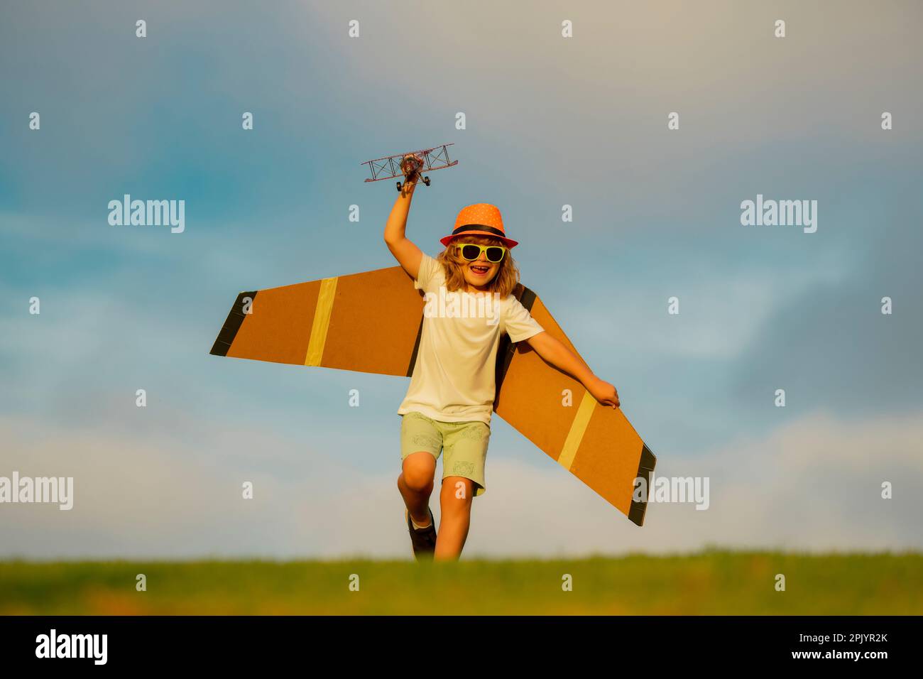 Child playing. Child boy toddler playing with toy airplane wings and ...