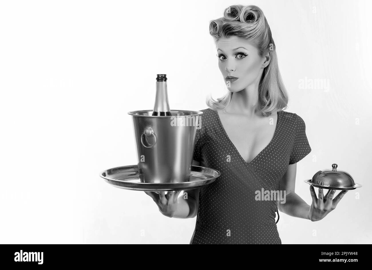 Pin up waiter with champagne and service tray. Restaurant serving presentation. Stock Photo